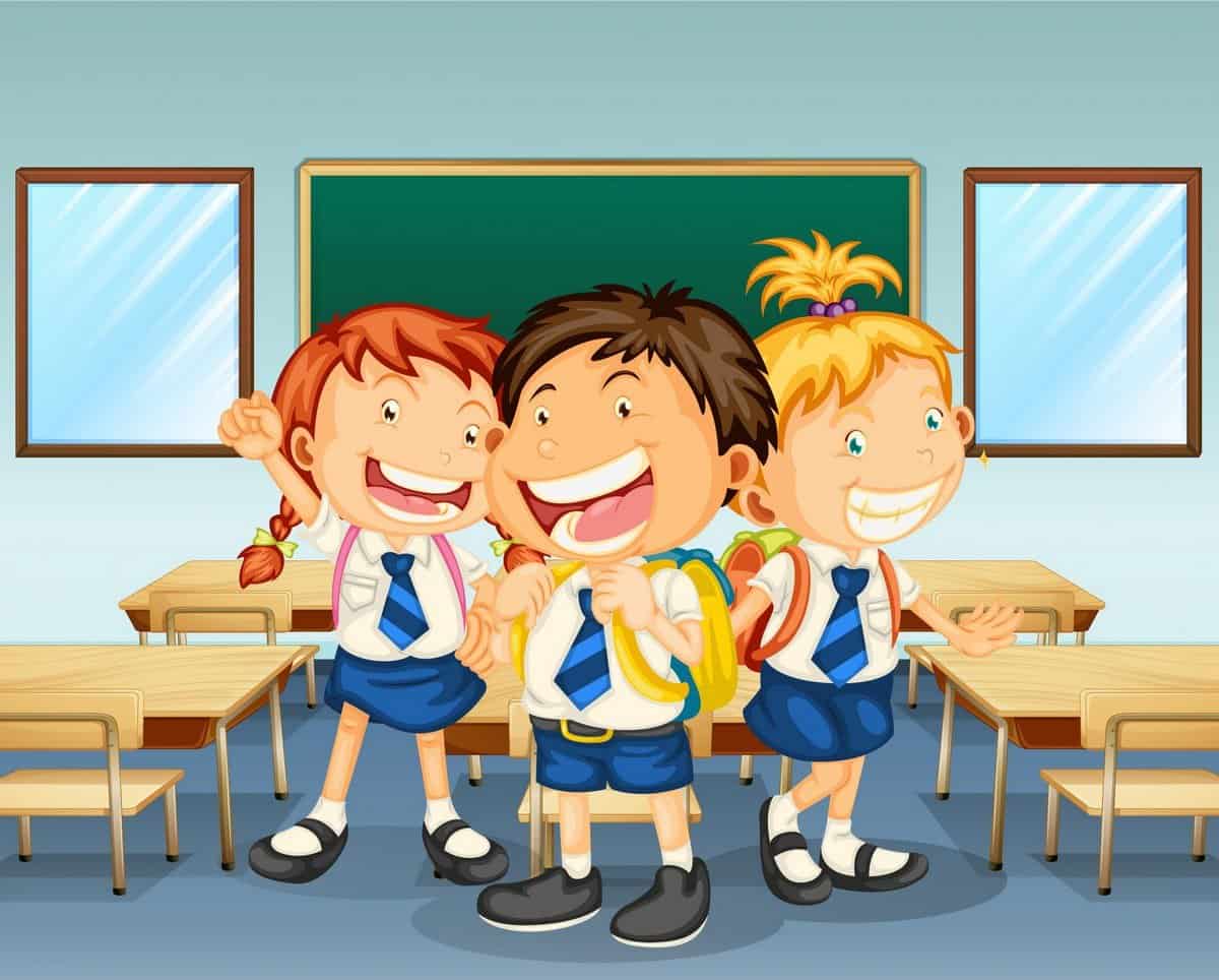 Three children smiling inside the classroom