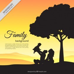 Background of lovely family scene with baby in the field at sunset