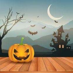 Halloween pumpkin against spooky landscape